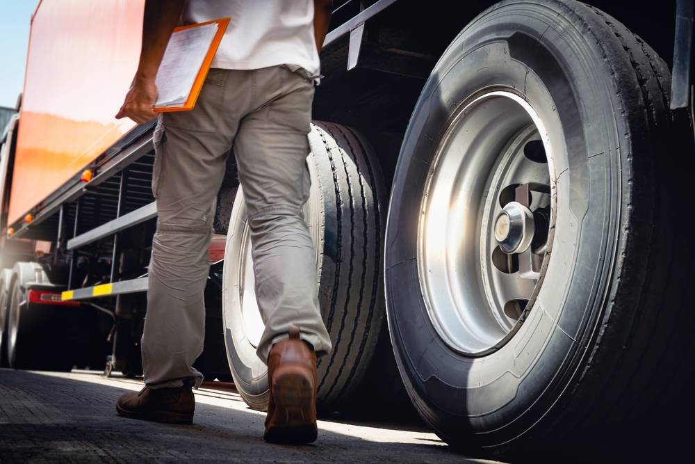 Photo of a man walking next to the truck