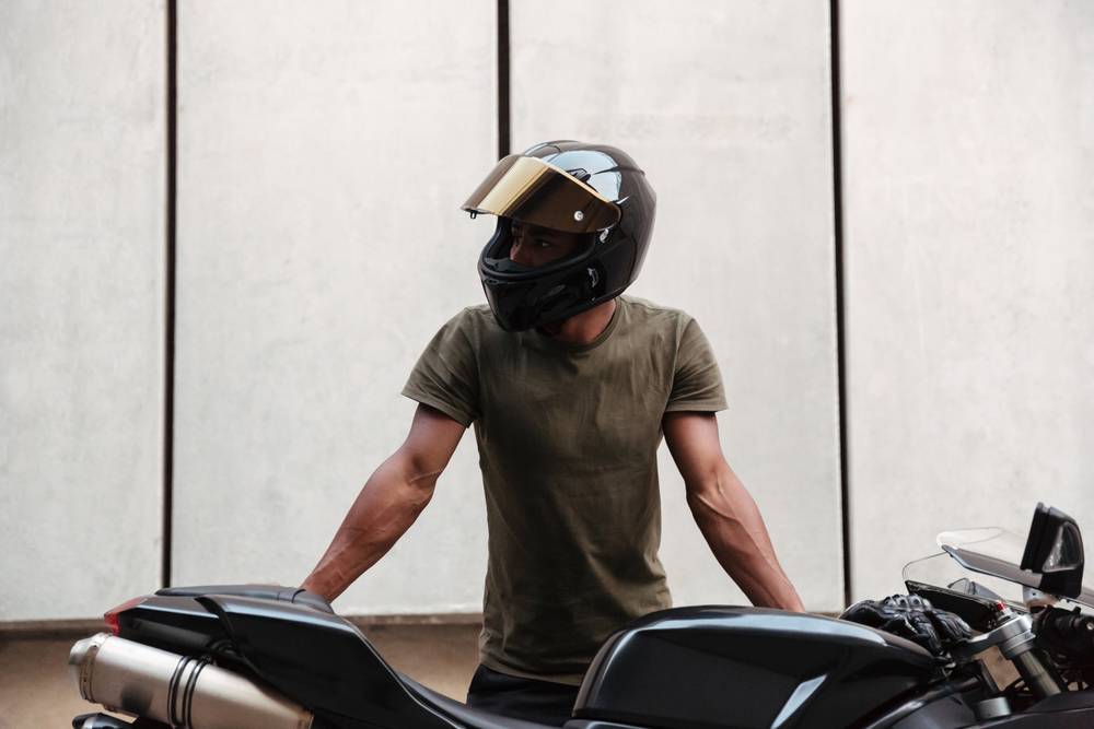 Photo of a man standing the bike