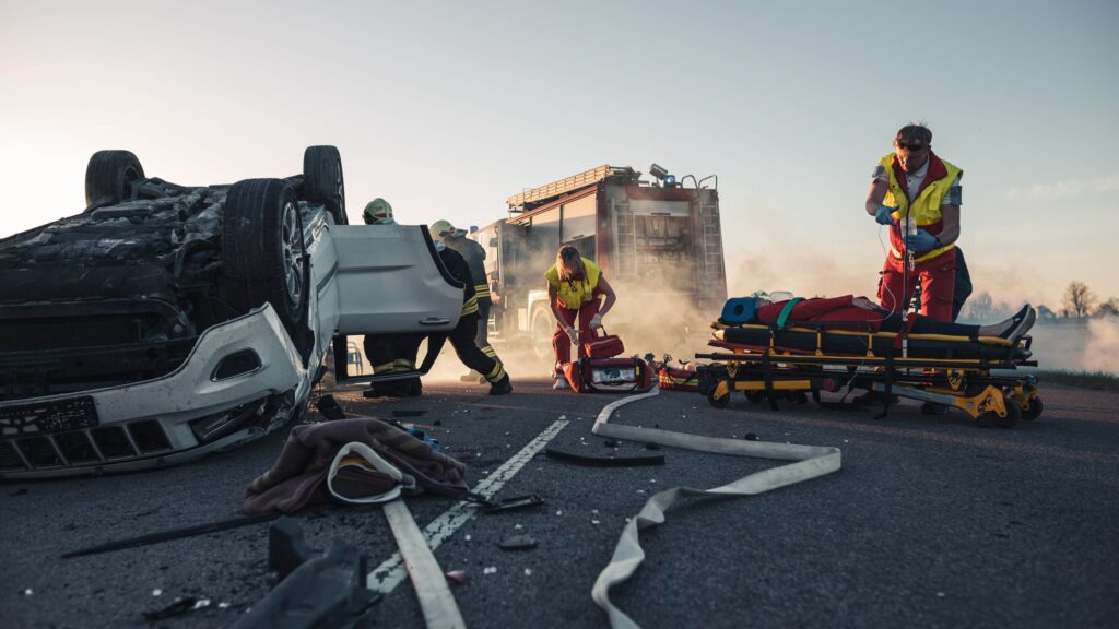 Paramedics and firefighters arrive at the scene of a car accident