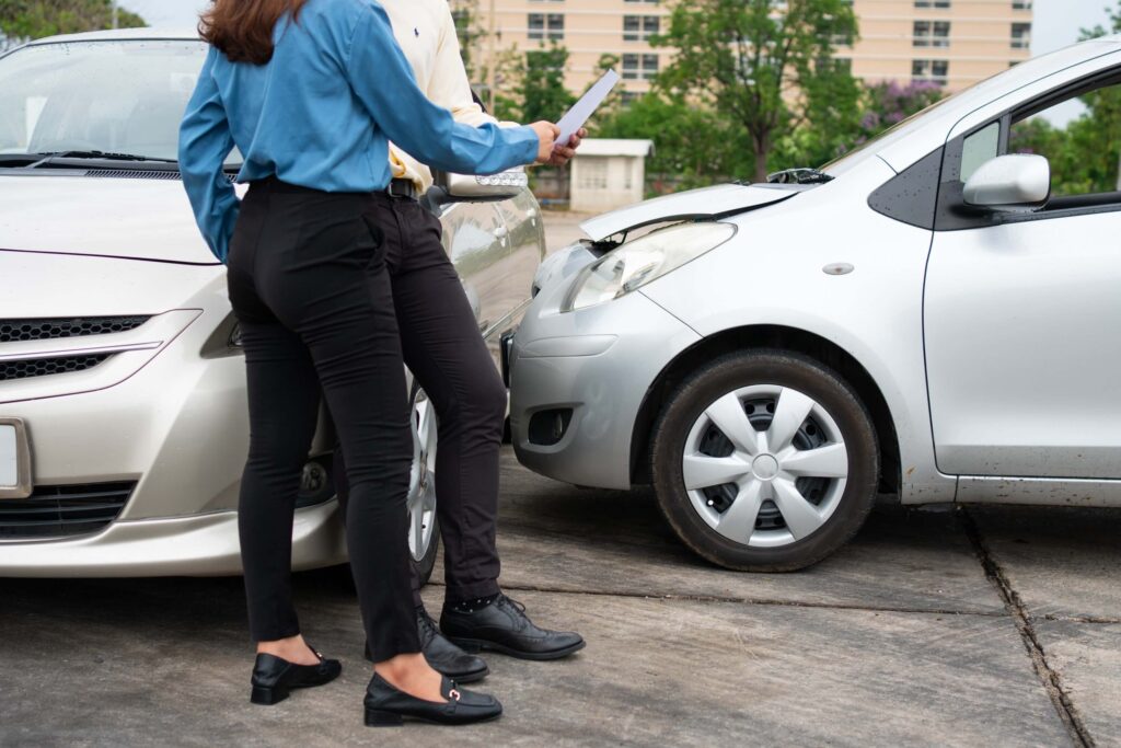 Two drivers use smartphone to exchange phone numbers and social media after car accident