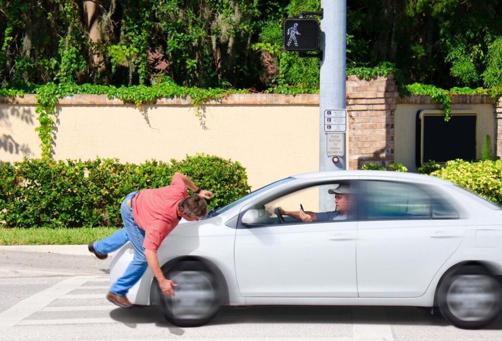 A man texting while driving runs over a pedestrian