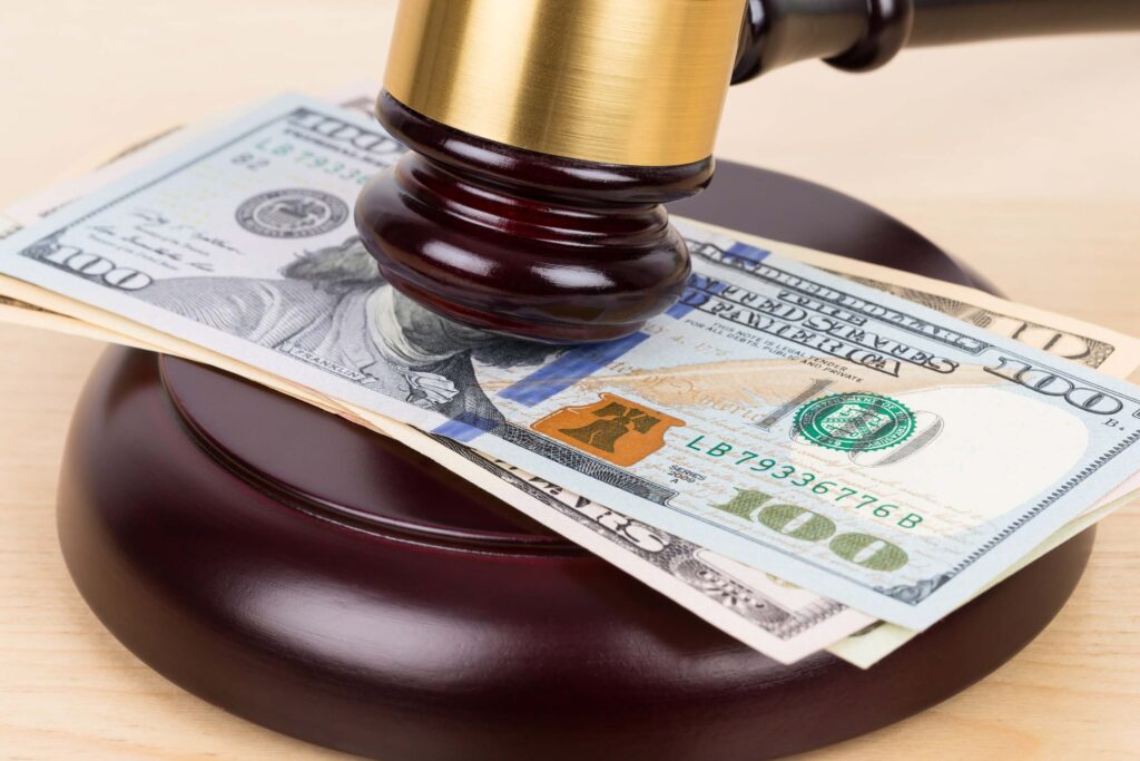 Judge wooden gavel with dollar money bill bribery concept