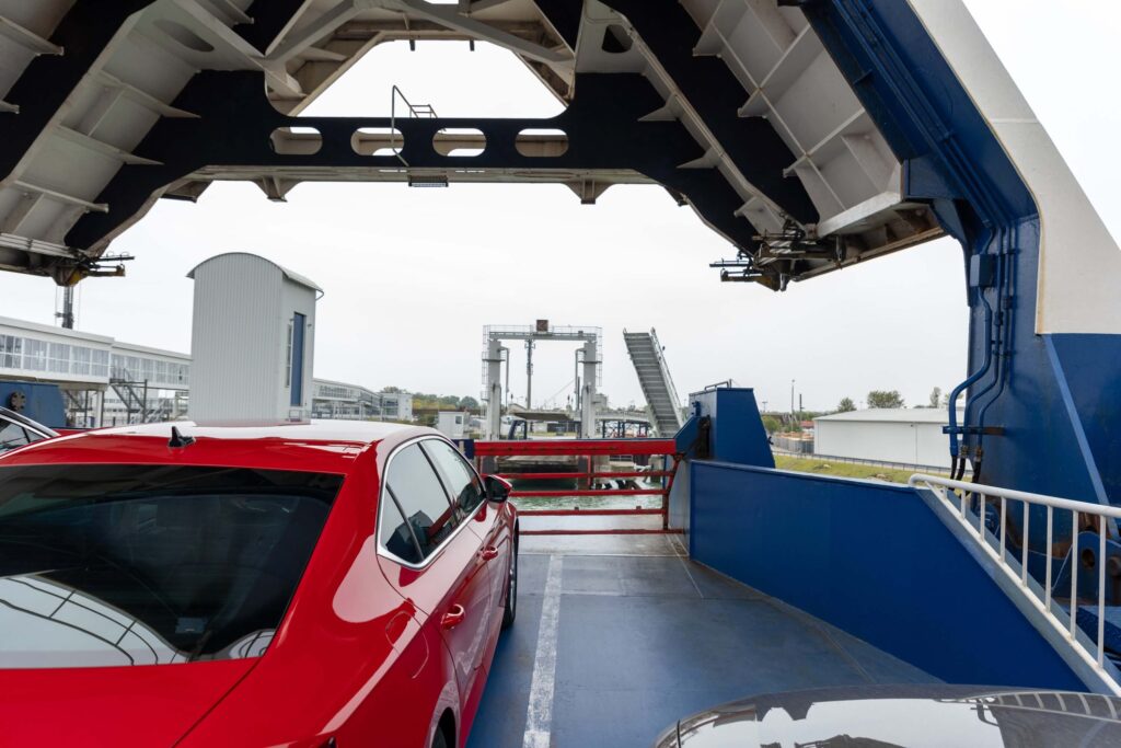 Front open door of passenger cargo ferry ship with loaded cars and vehicles